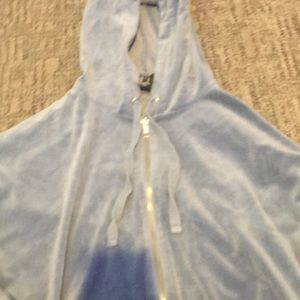 A cropped lighter blue jacket with hood and zipper